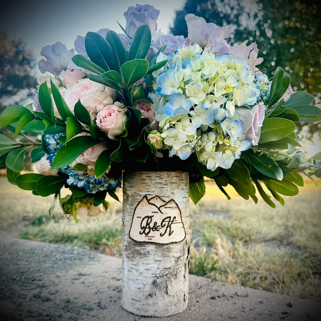 Mountain customized vase with purple and pink rose floral arrangement