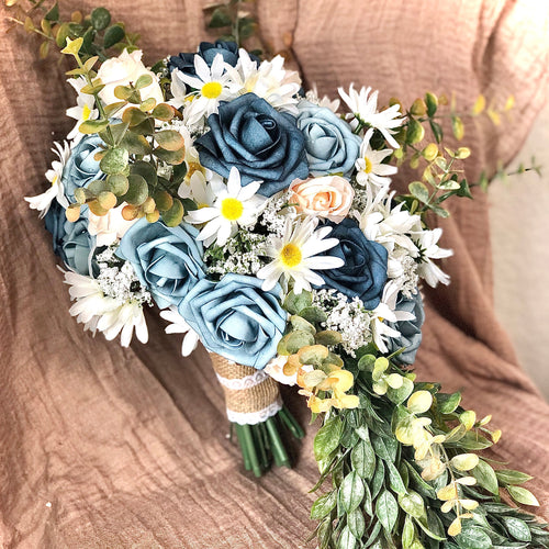 Cascading dusty blue bridal bouquet with daises babies breath navy and cream roses
