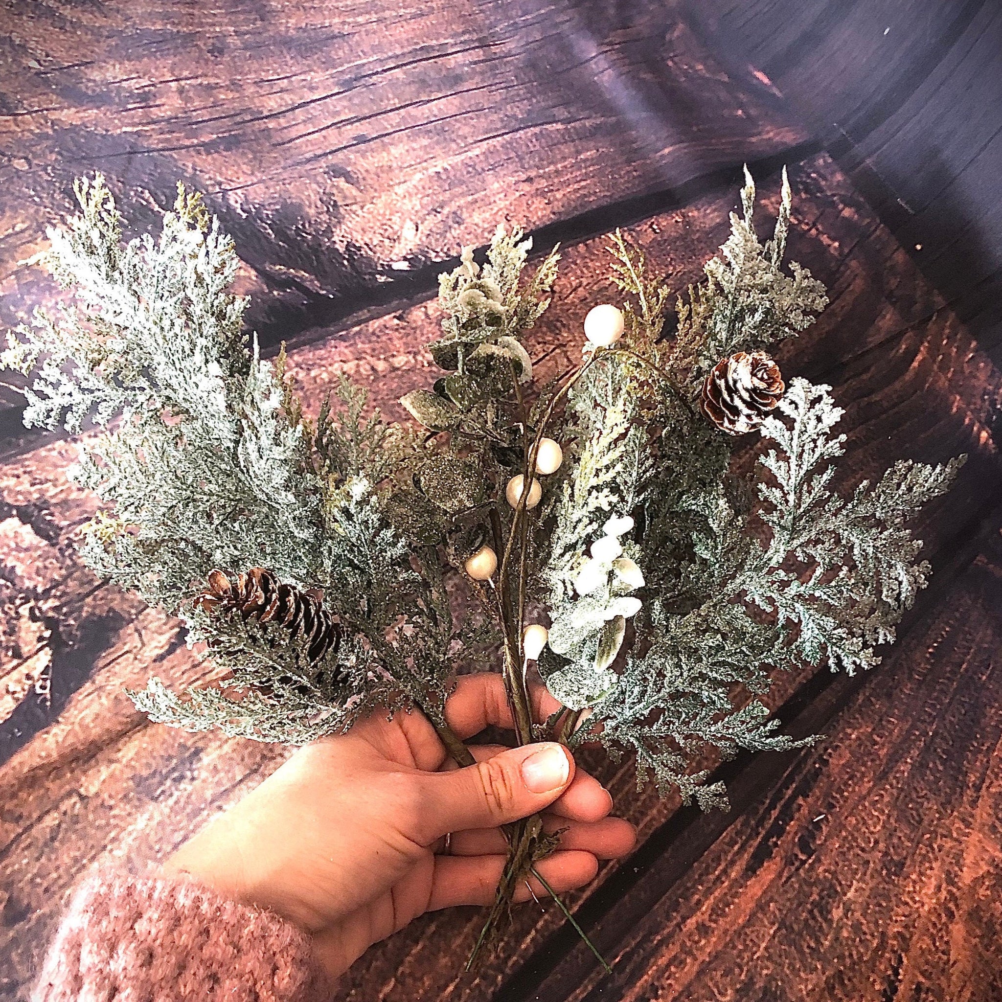Glittered cedar and eucalyptus winter floral arrangement